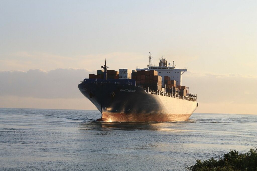 A heavily-laden cargo freighter approaches land.