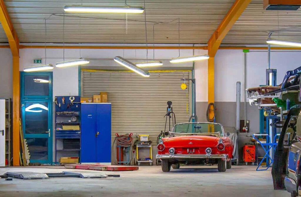 A red classic car in a garage