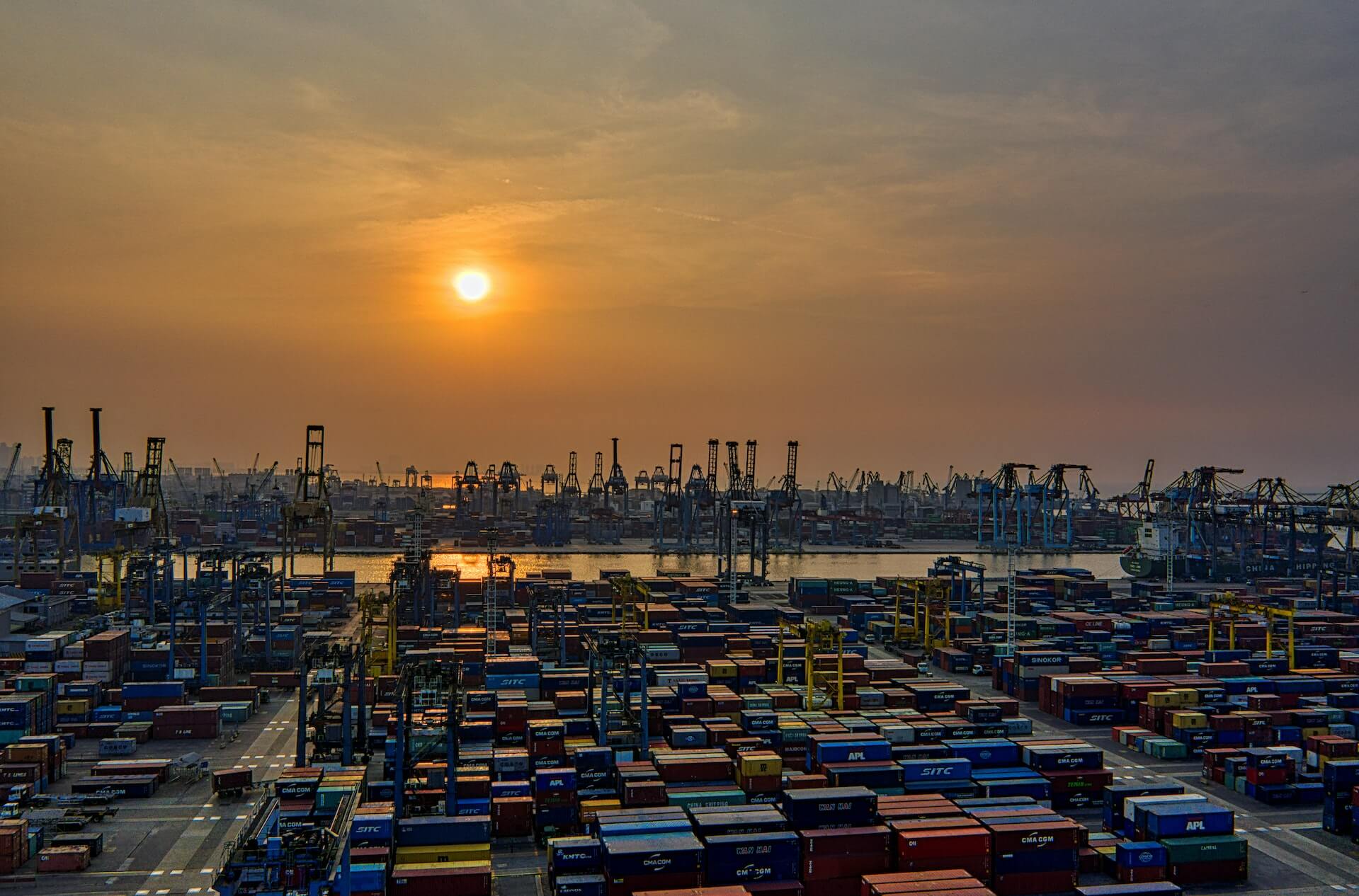 Photo of a large overseas shipping port filled with containers. 